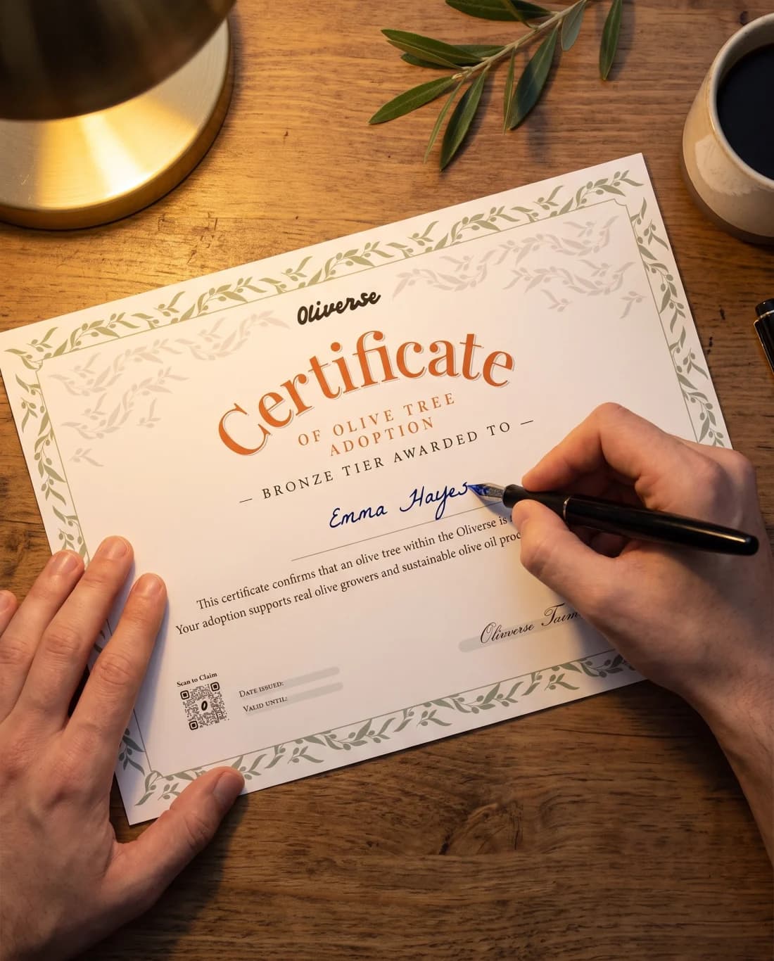 Someone signing an Oliverse adoption certificate